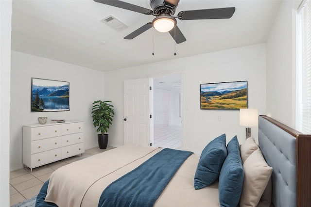 bedroom with ceiling fan and light tile patterned floors