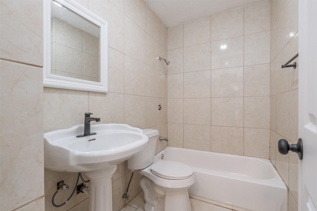 3912 Valentine St, Fort Worth, TX 76107 - bathroom with tile walls, bathing tub / shower combination, toilet, and tile patterned flooring