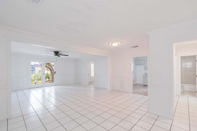 unfurnished room featuring ornamental molding, light tile patterned floors, and ceiling fan