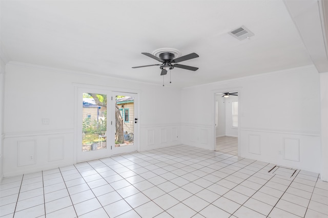 tiled empty room with ceiling fan and crown molding