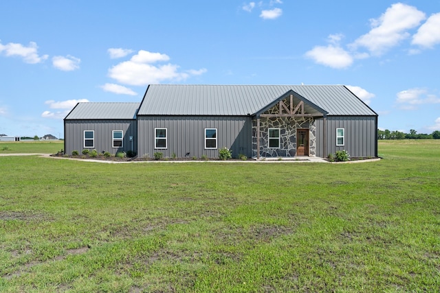 modern inspired farmhouse with an outdoor structure and a front lawn