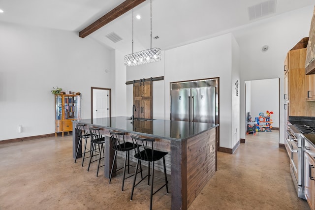 kitchen featuring decorative light fixtures, a breakfast bar area, a center island, concrete floors, and premium appliances