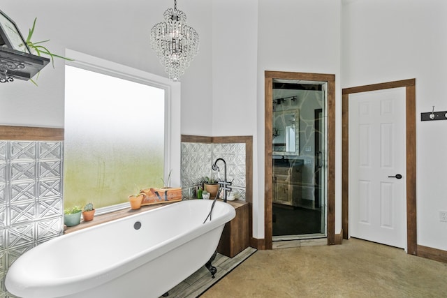 bathroom with an inviting chandelier, tile walls, and plus walk in shower