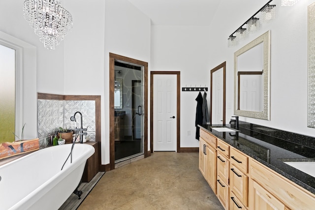 bathroom with concrete floors, dual vanity, shower with separate bathtub, and an inviting chandelier