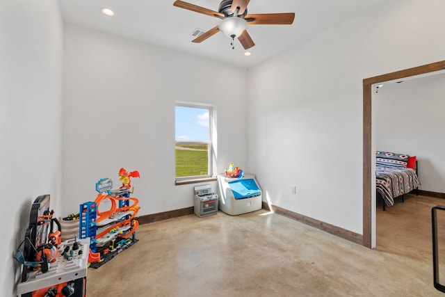 recreation room with concrete floors and ceiling fan