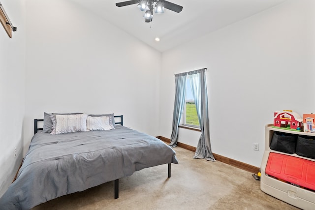 carpeted bedroom with vaulted ceiling and ceiling fan