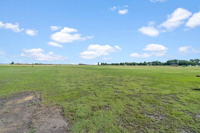 view of yard with a rural view