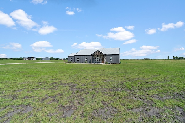 view of yard with a rural view and an outdoor structure