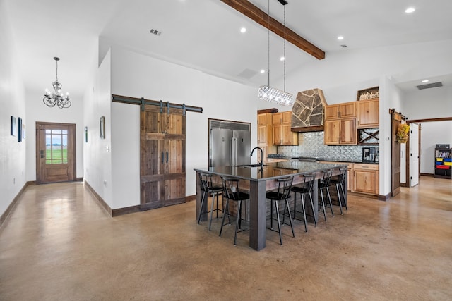 dining room featuring high vaulted ceiling, concrete flooring, a barn door, and a chandelier