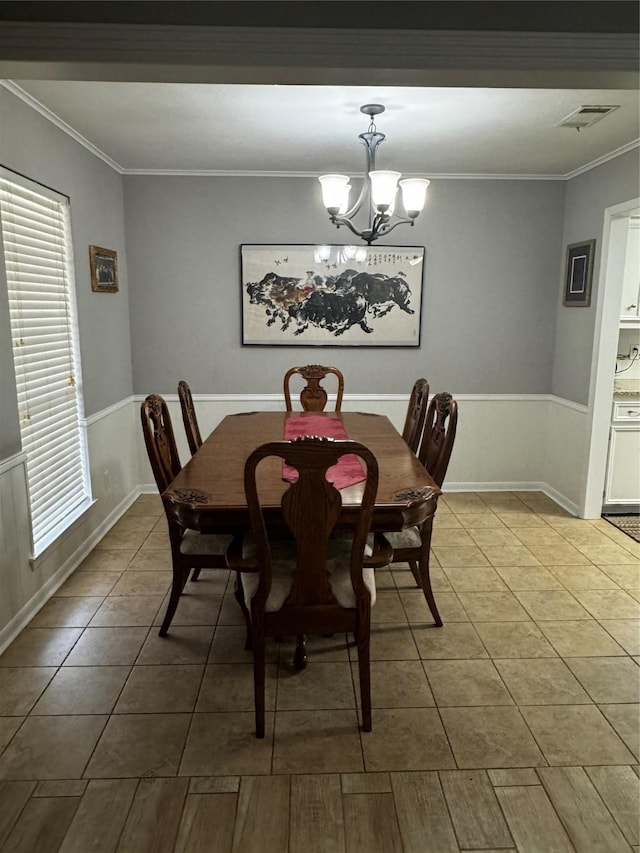 dining room featuring ornamental molding, a notable chandelier, and hardwood / wood-style floors