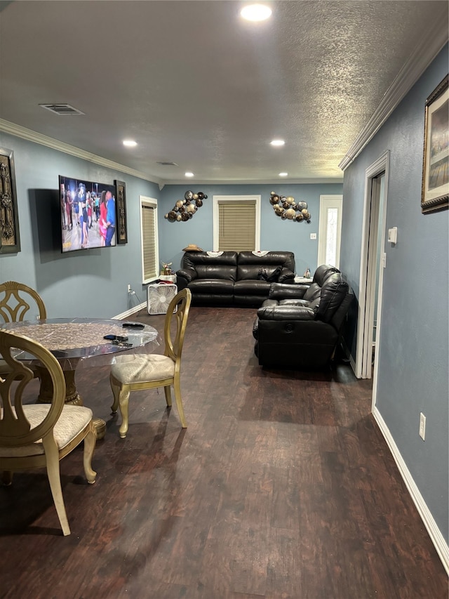 living room featuring ornamental molding, a textured ceiling, and dark hardwood / wood-style floors