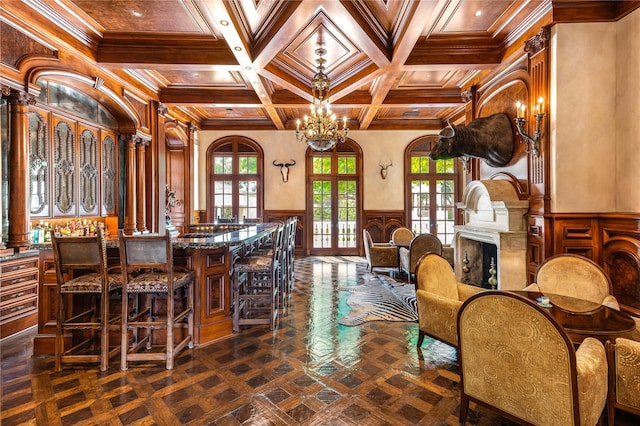 dining space featuring an inviting chandelier, coffered ceiling, crown molding, beam ceiling, and french doors