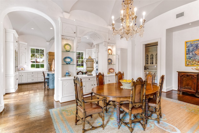 dining room featuring high vaulted ceiling, a chandelier, and hardwood / wood-style flooring