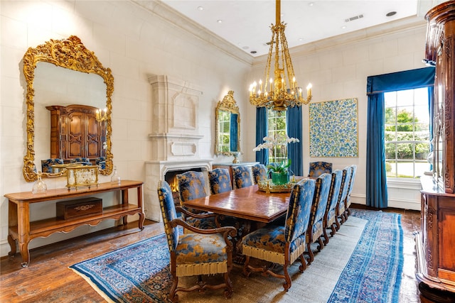 dining room featuring an inviting chandelier, tile walls, dark hardwood / wood-style floors, and crown molding