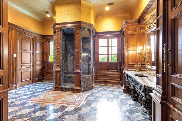 bathroom with lofted ceiling, sink, plenty of natural light, and ornate columns