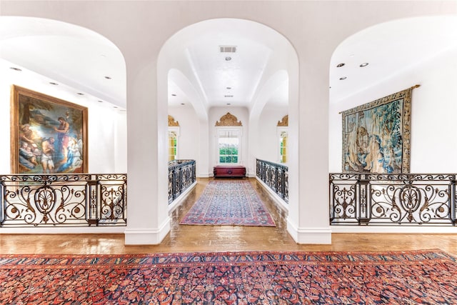 hall with hardwood / wood-style flooring