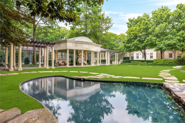 view of swimming pool featuring a pergola and a lawn