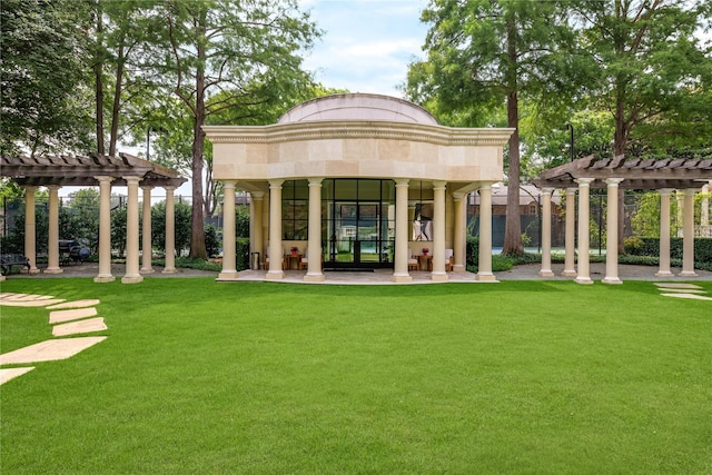 rear view of house with a pergola and a lawn