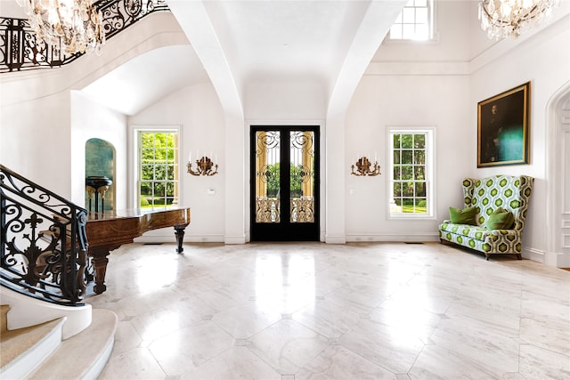 foyer featuring an inviting chandelier, light tile flooring, and a wealth of natural light