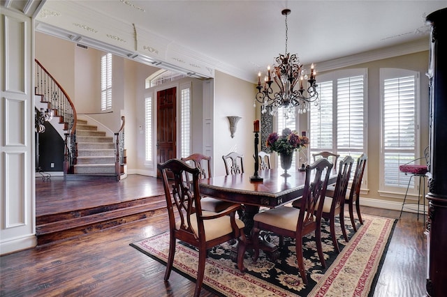 dining area with ornamental molding, a healthy amount of sunlight, a chandelier, and dark wood-type flooring