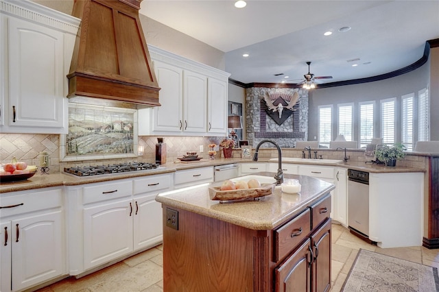 kitchen featuring kitchen peninsula, white cabinetry, custom range hood, and a kitchen island