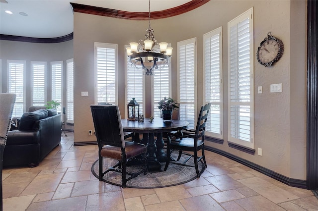 dining area featuring crown molding and a notable chandelier