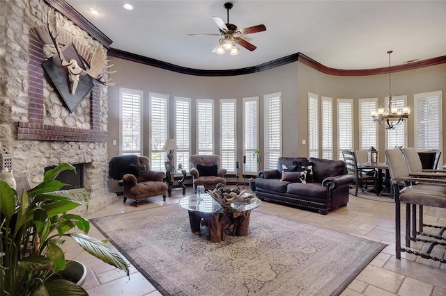 living room with crown molding, a fireplace, ceiling fan with notable chandelier, and a high ceiling