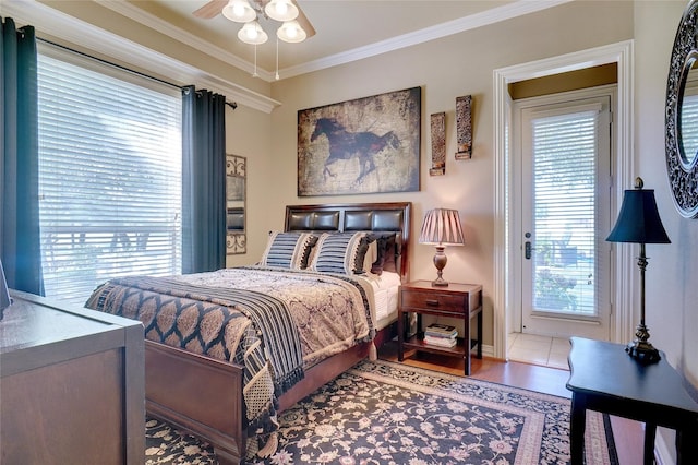 bedroom featuring ornamental molding, light tile patterned floors, and ceiling fan