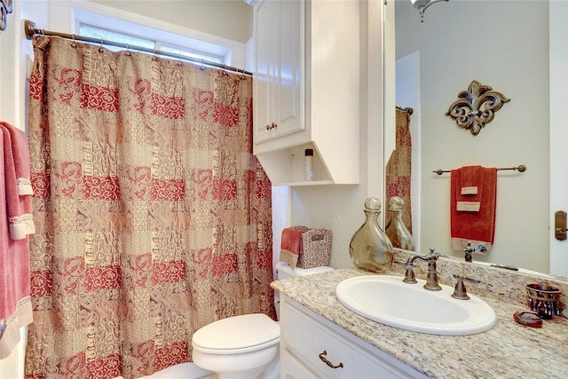 bathroom with vanity, toilet, and walk in shower