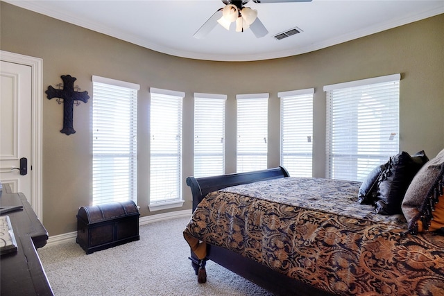 bedroom with ornamental molding, carpet, and ceiling fan