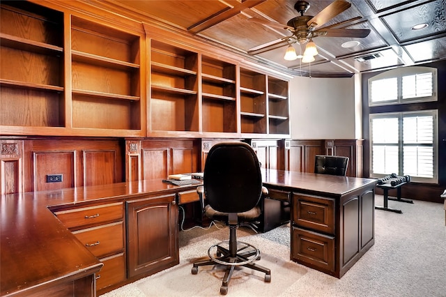 carpeted office space featuring built in desk, coffered ceiling, and ceiling fan