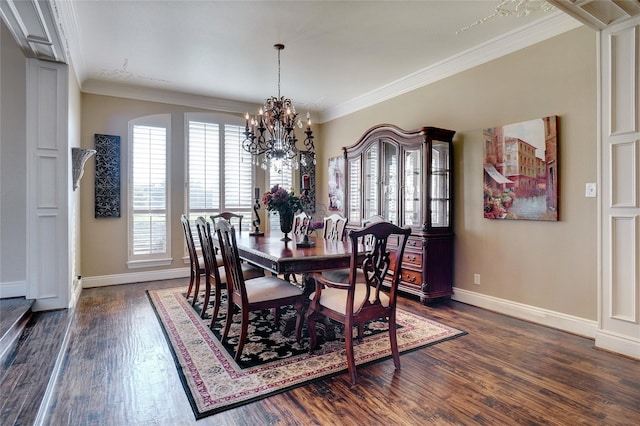 dining space with an inviting chandelier, ornamental molding, and dark hardwood / wood-style flooring