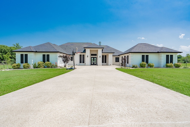 prairie-style home featuring a front lawn