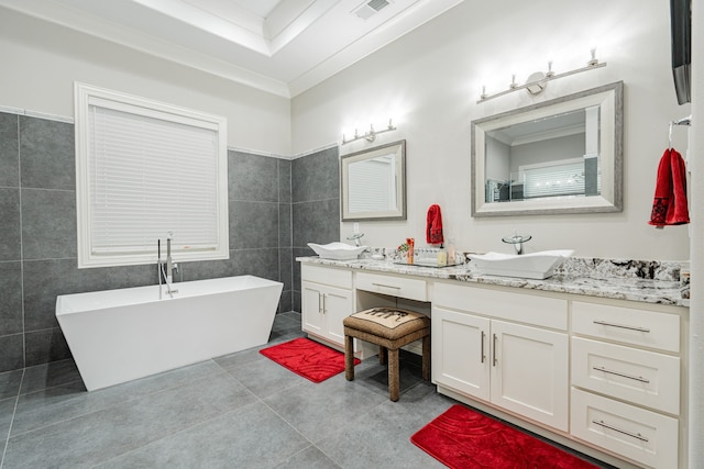 bathroom with tile walls, double vanity, tile flooring, and a bath