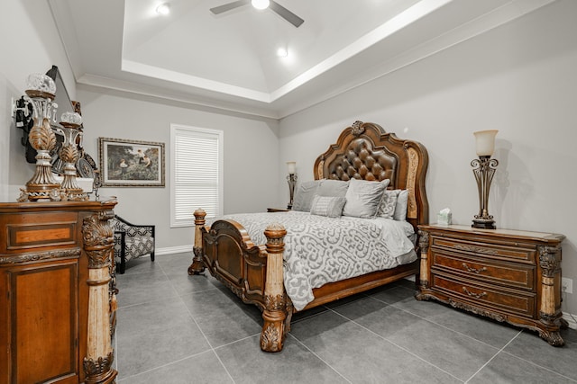 bedroom with tile floors, ceiling fan, and a raised ceiling