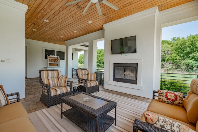 living room featuring ceiling fan and wooden ceiling