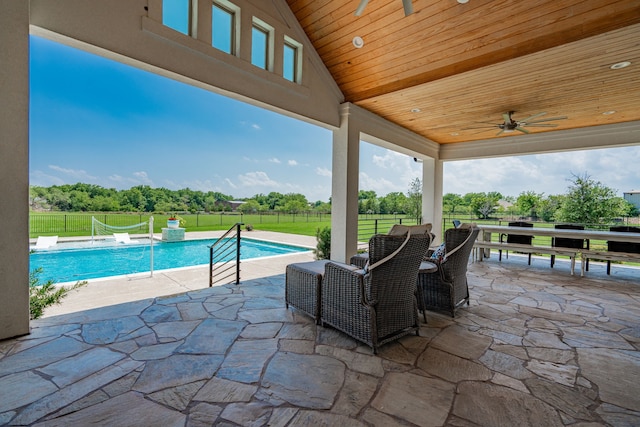 view of pool with a yard, a patio area, and ceiling fan