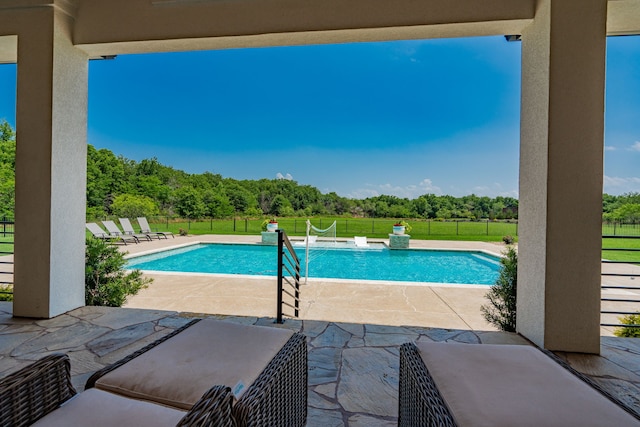 view of pool featuring a patio and a yard