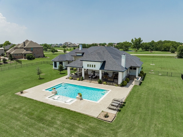 view of pool with a patio area and a yard