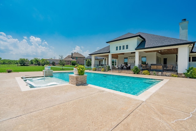 view of pool featuring a patio area, pool water feature, and ceiling fan