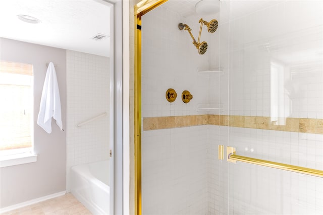 bathroom with tile patterned floors and independent shower and bath