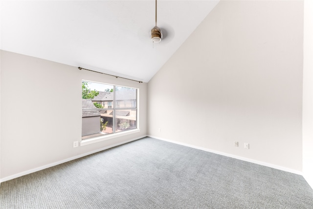 carpeted empty room featuring high vaulted ceiling