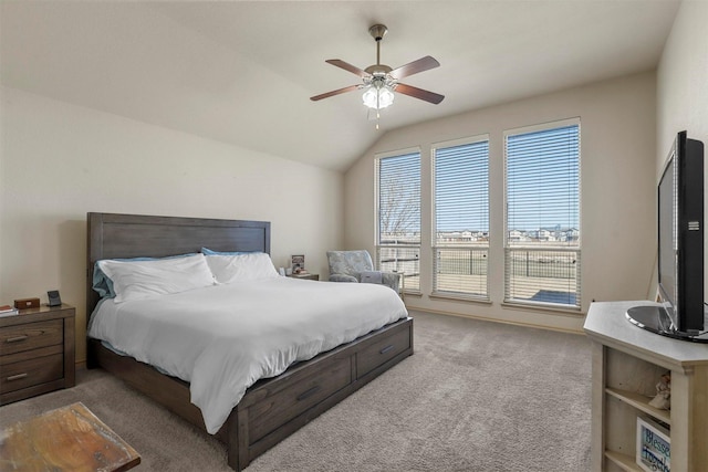 bedroom featuring lofted ceiling, carpet flooring, and a ceiling fan