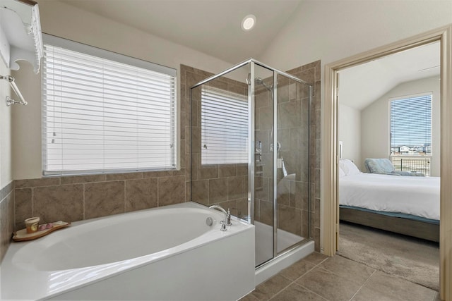 full bath featuring vaulted ceiling, a shower stall, a bath, and ensuite bathroom