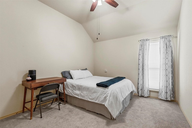 carpeted bedroom with multiple windows, baseboards, vaulted ceiling, and a ceiling fan