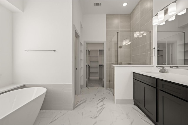 full bath with visible vents, a shower stall, marble finish floor, and a walk in closet