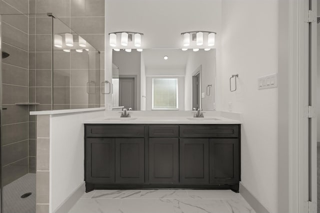 bathroom with a sink, marble finish floor, and a stall shower