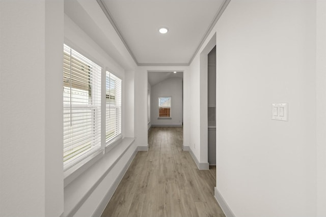 hall with baseboards and light wood-type flooring