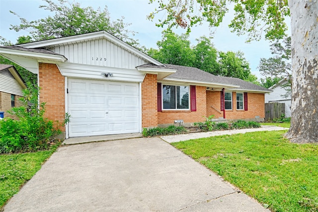 view of front of home with a garage and a front lawn