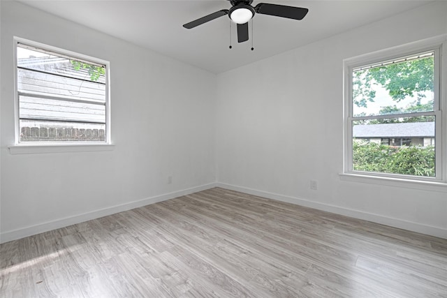 unfurnished room with ceiling fan and light wood-type flooring